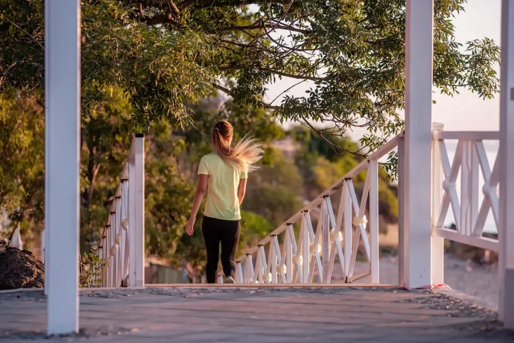 A woman takes a mental health break to go for a walk.