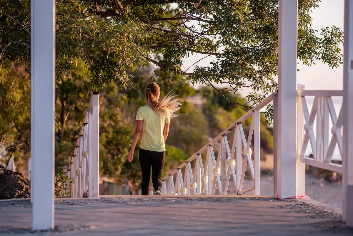 A woman takes a mental health break to go for a walk.