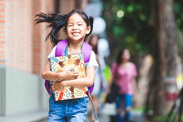 A young student holding a datebook.