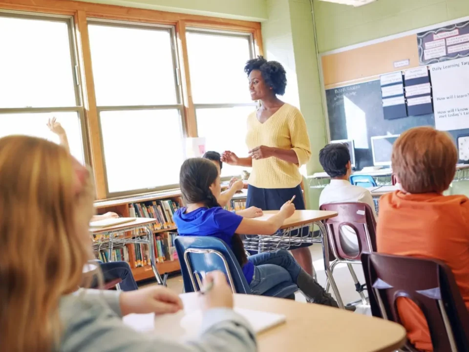 Teacher explains lesson to students in a classroom.