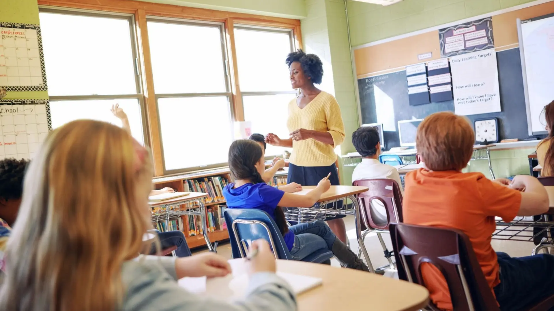Teacher explains lesson to students in a classroom.